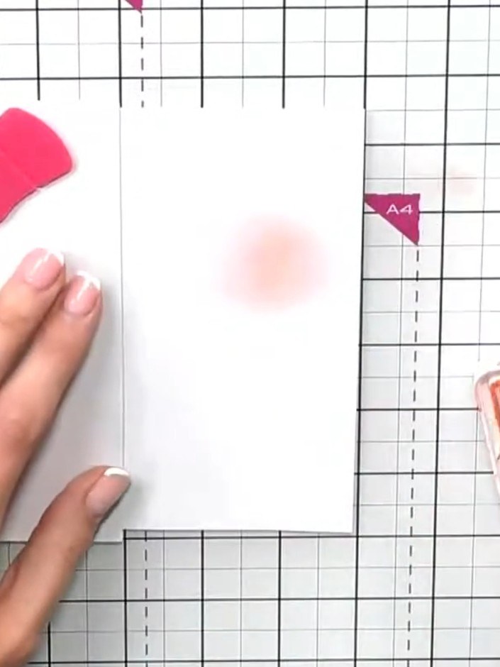 Step 4: Using a blending brush, apply orange ink along the masked edge to create a warm glow effect. Tap off excess in