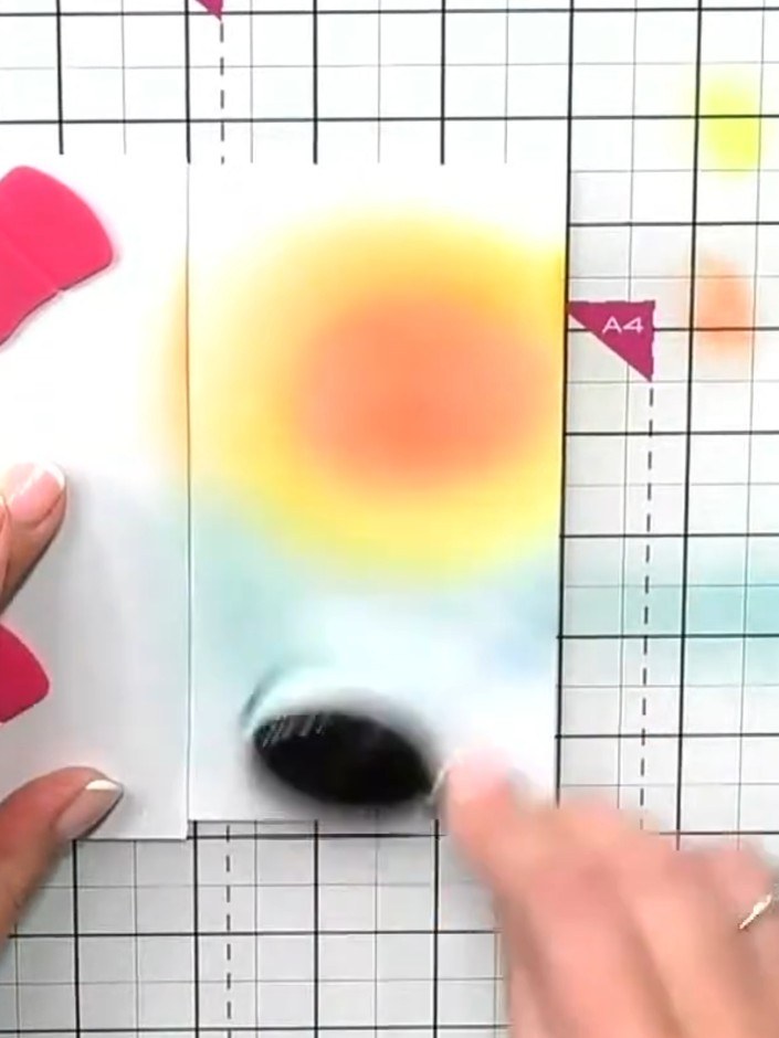 Step 9: Spray water droplets across the ink-blended background to create texture and add visual interest. The water wi