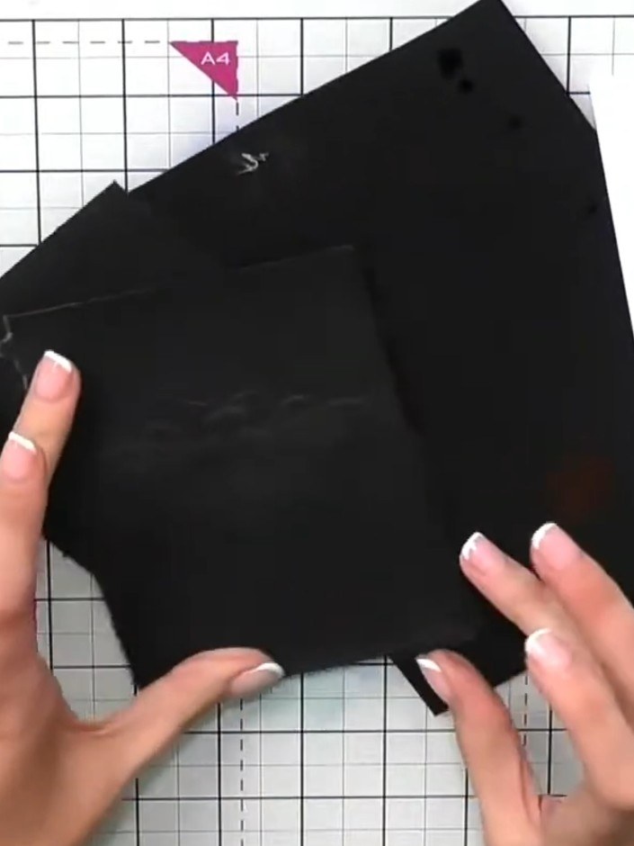 Step 7: Trim the embossed black card to your desired finished size using scissors or a trimmer. The card should be tri