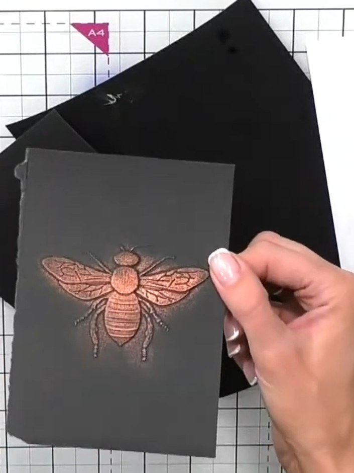Step 8: Mount the embossed grey card panel onto a black card base to create your finished card. The embossed bee desig