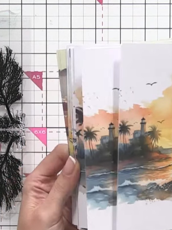 Step 1: Select a piece of Dawn paper featuring the landscape silhouette design with sunset colours and palm trees. Thi