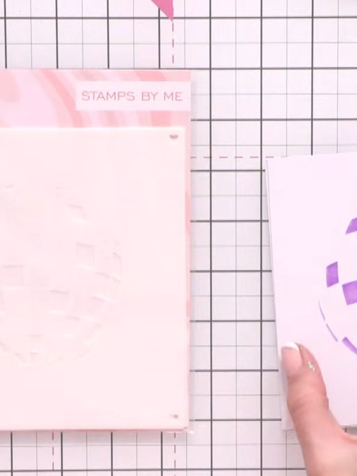 Step 1: Position your first layering stencil on the card and ink the four corner hearts as positioning guides. These h