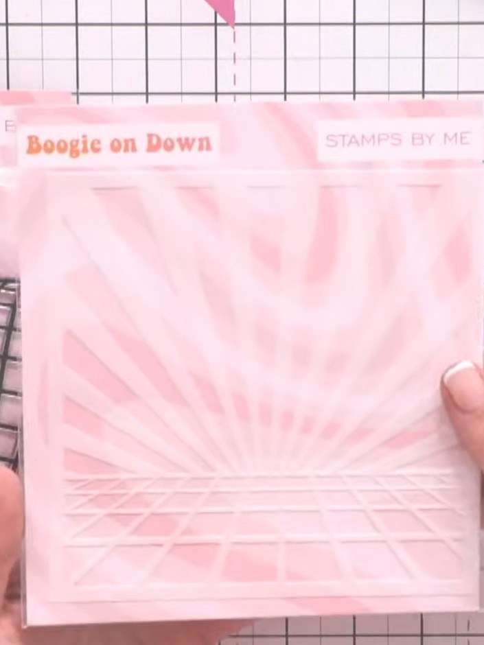 Step 7: Position the disco ball and decorative elements on your card front, arranging them over the pink starburst bac
