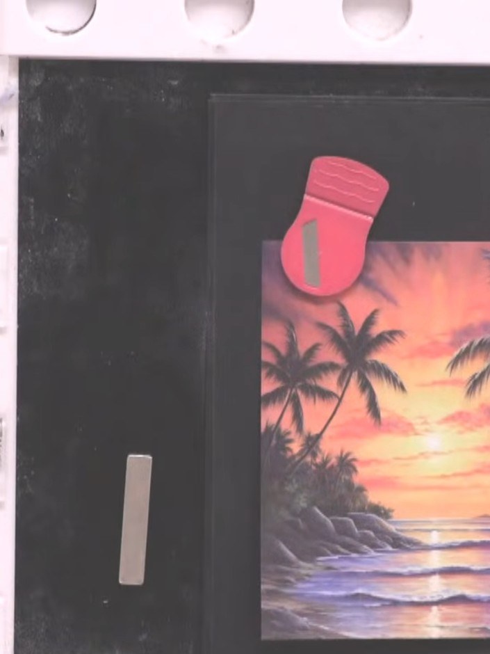 Step 7: Position the stamped tropical sunset scene onto the black card base. Secure in place with adhesive, ensuring t