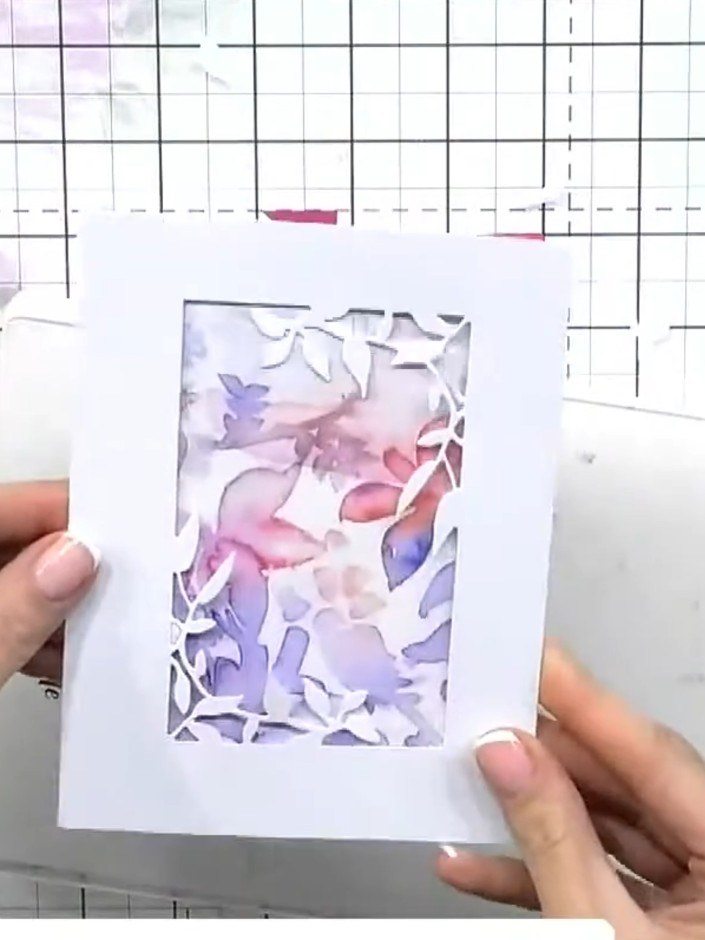 Step 6: Apply glue to the back of the foliage die-cut pieces and layer them onto the card front, offsetting and buildi