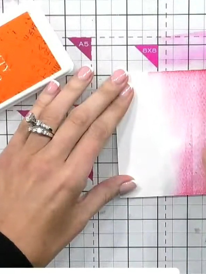 Step 2: Swipe the orange ink pad into the middle area of the card, blending it with the pink to create a gradient effe