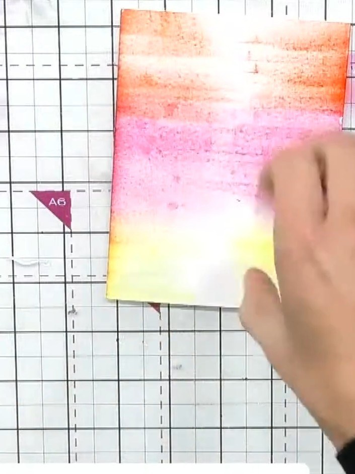 Step 4: Dampen your brush with water and blend the yellow, pink and orange inks together on the card, working the colo
