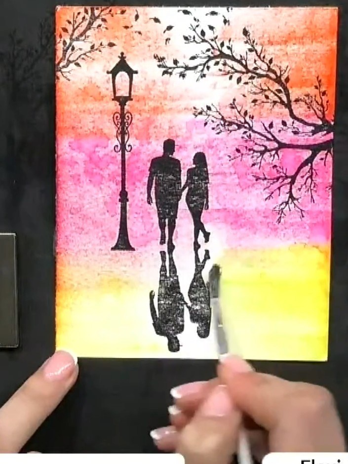 Step 7: Use a damp brush to blend the stamped silhouettes into the watercolour background. Pull the colour downwards f