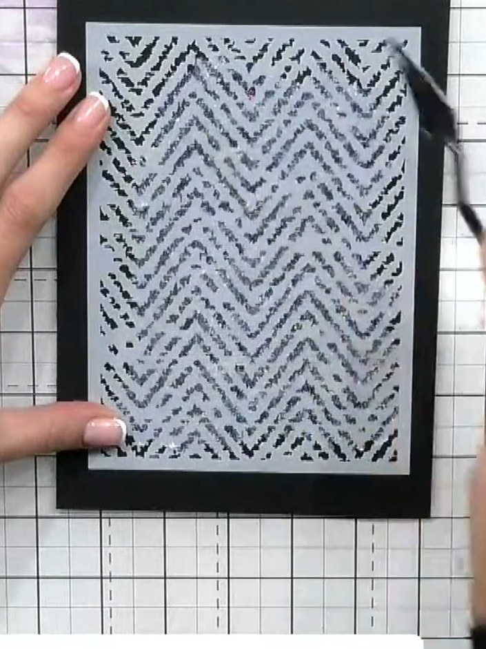 Step 3: Place the herringbone stencil over your black card. Using a palette knife or spatula, dab the Funky Fossil Ste