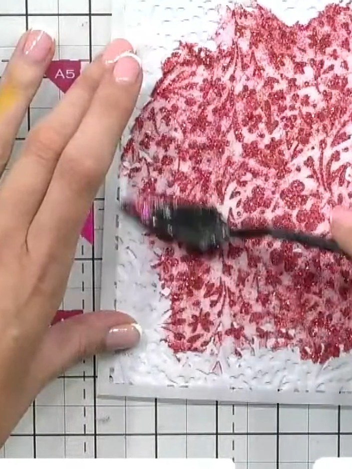 Step 3: Using a palette knife or spatula, spread the pink paste evenly across all the openings of the ditsy floral ste