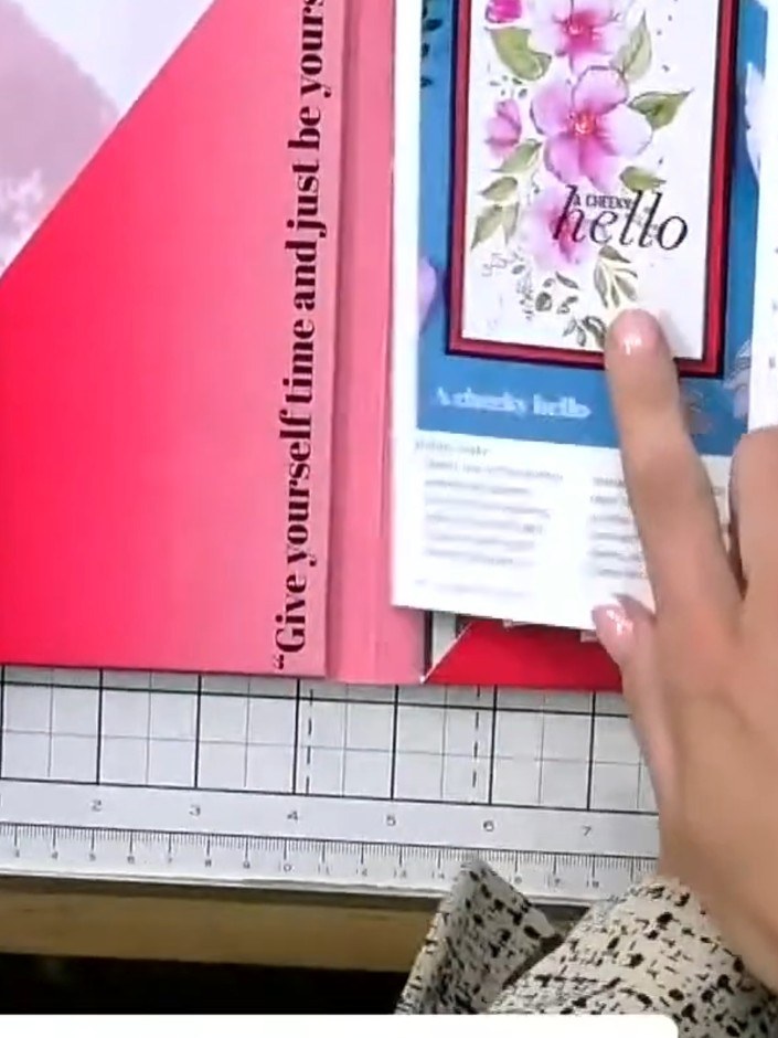 Step 1: Locate the pre-printed card template with faint halo outlines. This card features pink floral designs with the