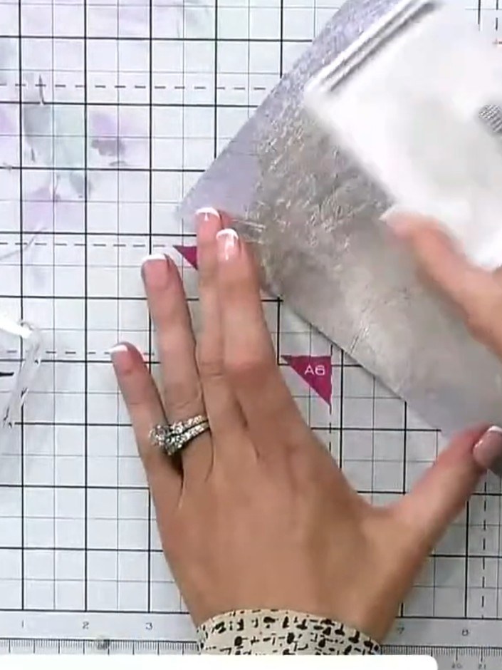 Step 5: Apply pink ink around the embossed design using an ink pad, working around the edges of the figures to create 