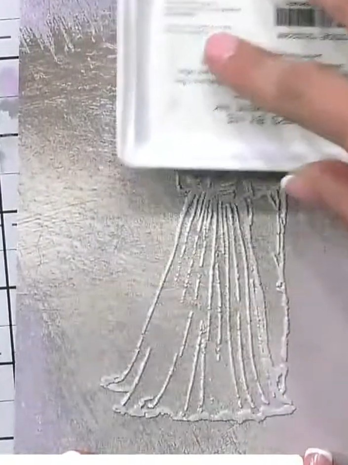 Step 6: Use a soft brush to gently blend and soften any harsh lines or edges created by the ink application on the emb