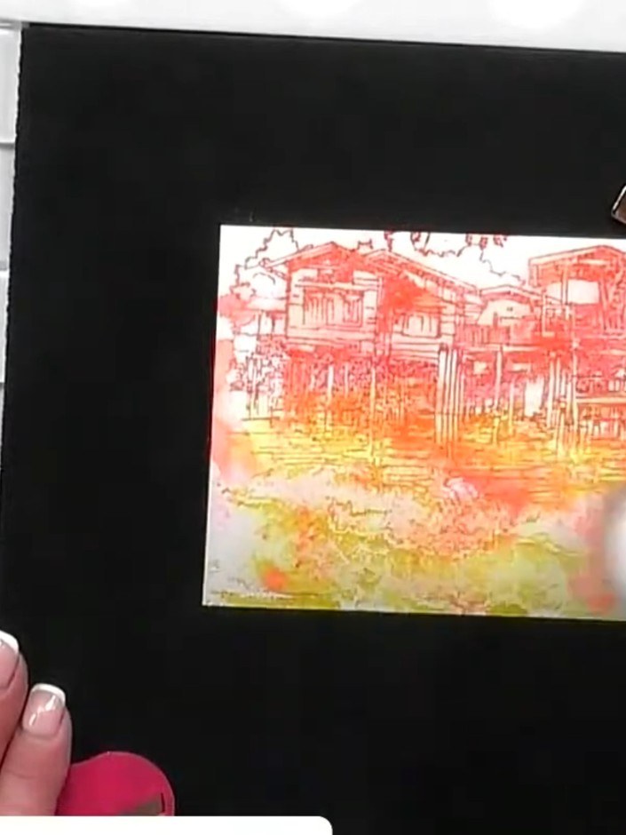 Step 8: Layer the watercolour scenic background onto the black card base. Add the decorative backing paper with the se
