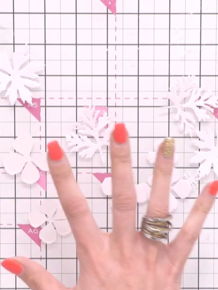 Step 1: Gather your die-cut flower pieces in various sizes. Select patterned papers with floral designs in coordinatin