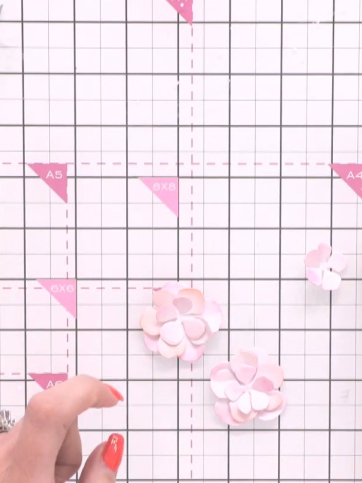 Step 11: Add gem embellishments to the centre of your finished layered flower for sparkle. Position the gems carefully 