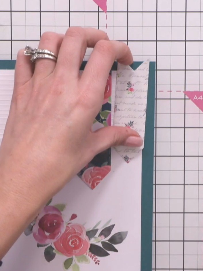 Step 8: Adhere one sentiment topper flat at the top of the white scored line. Add a second sentiment topper with a foa