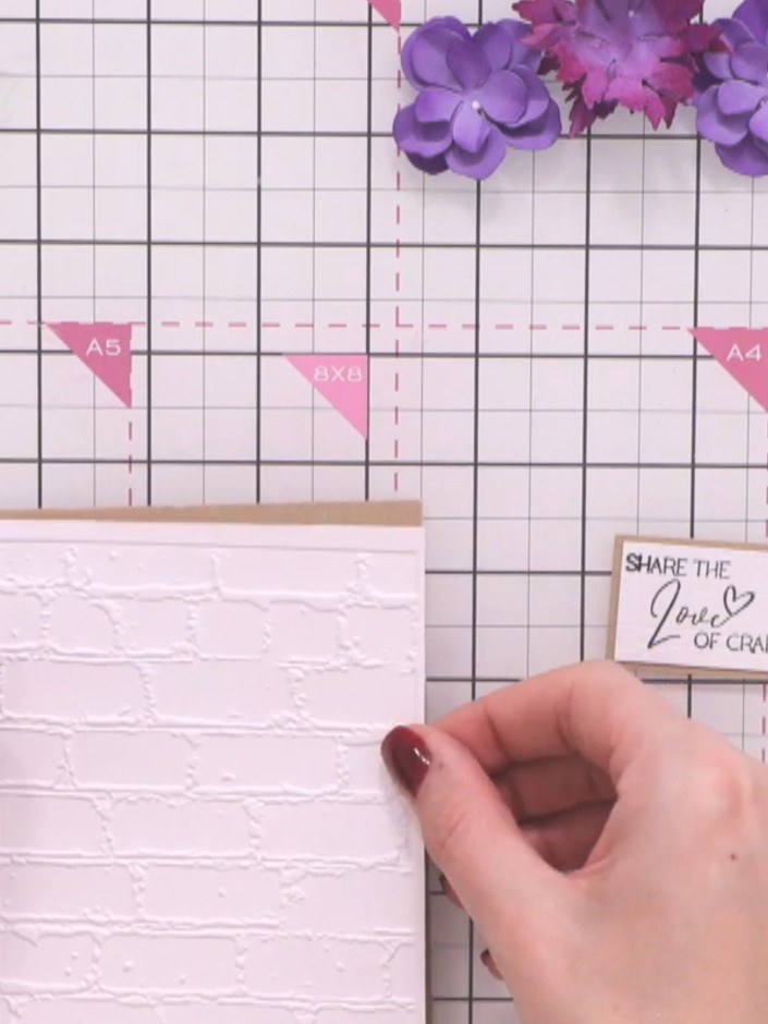 Step 11: Layer the white embossed brick background panel onto your kraft-coloured card base. Smooth down firmly to ensu