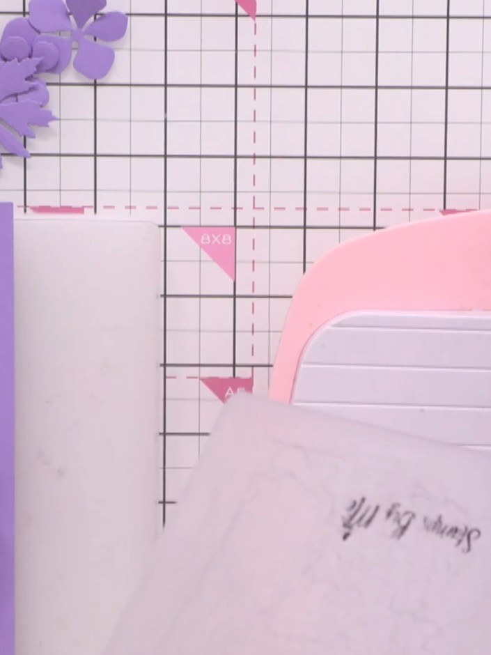 Step 4: Die cut the larger flower shape from purple card stock multiple times. Also die cut smaller flower shapes to c