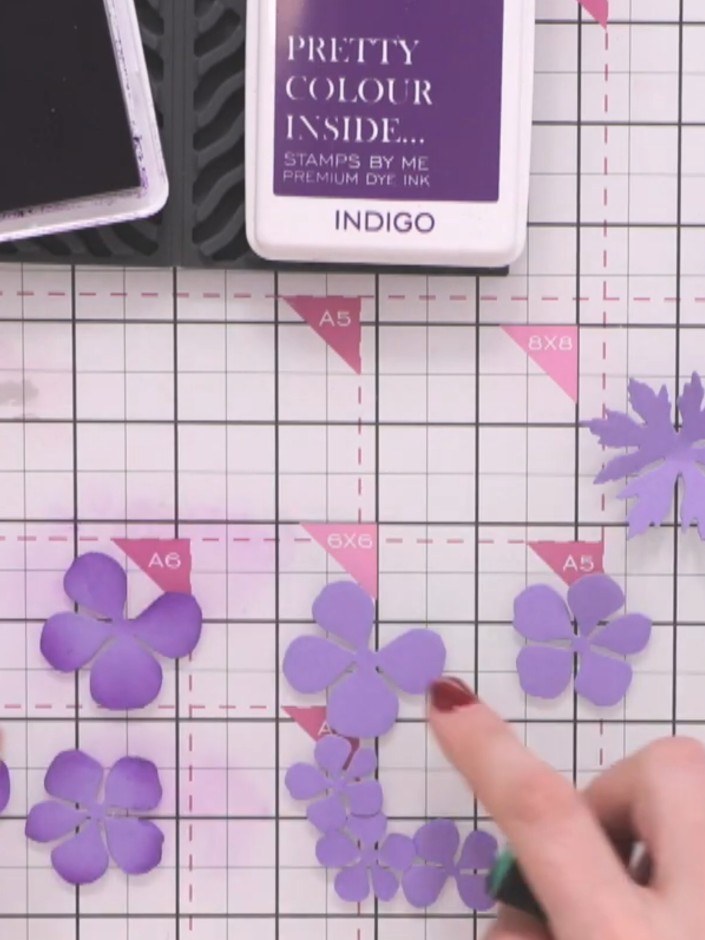 Step 6: Add pink ink to some of the purple flower pieces to create colour variation. Blend the ink gently onto selecte