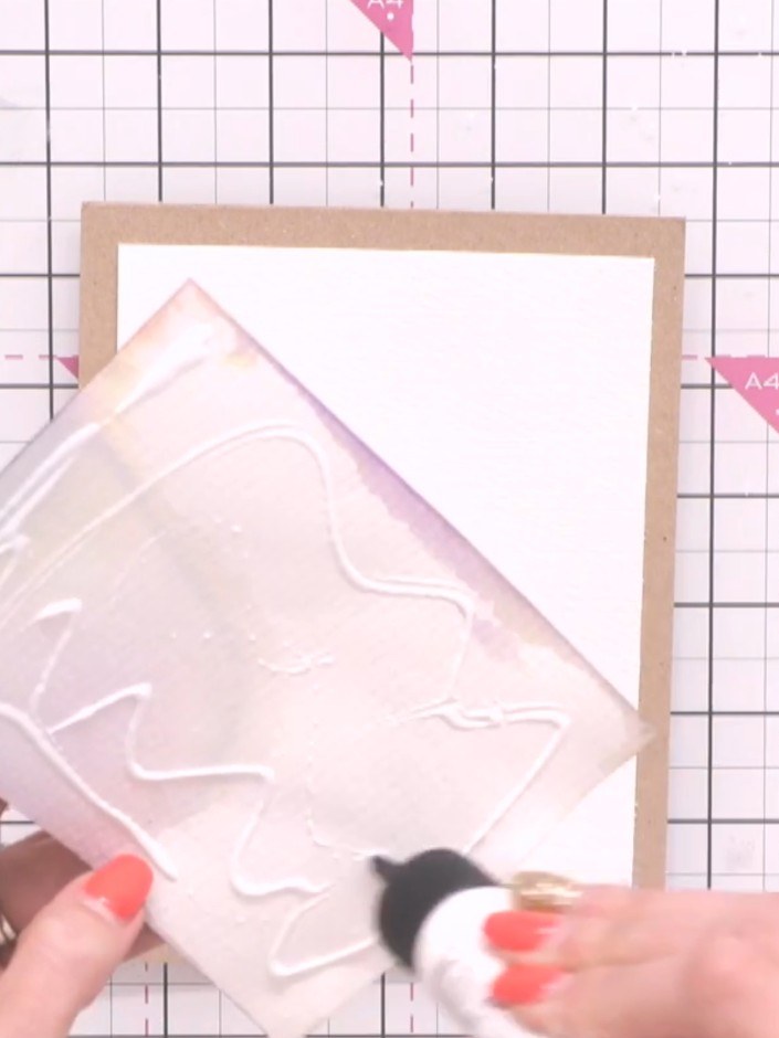 Step 12: Apply adhesive to the back of your white card panel and mount it onto the kraft card blank, ensuring an even b