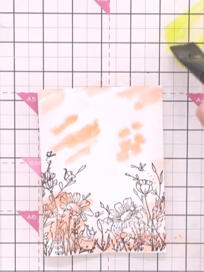 Step 4: Add yellow watercolour to the upper portion of the card, blending it with the orange. Keep the lighter colours