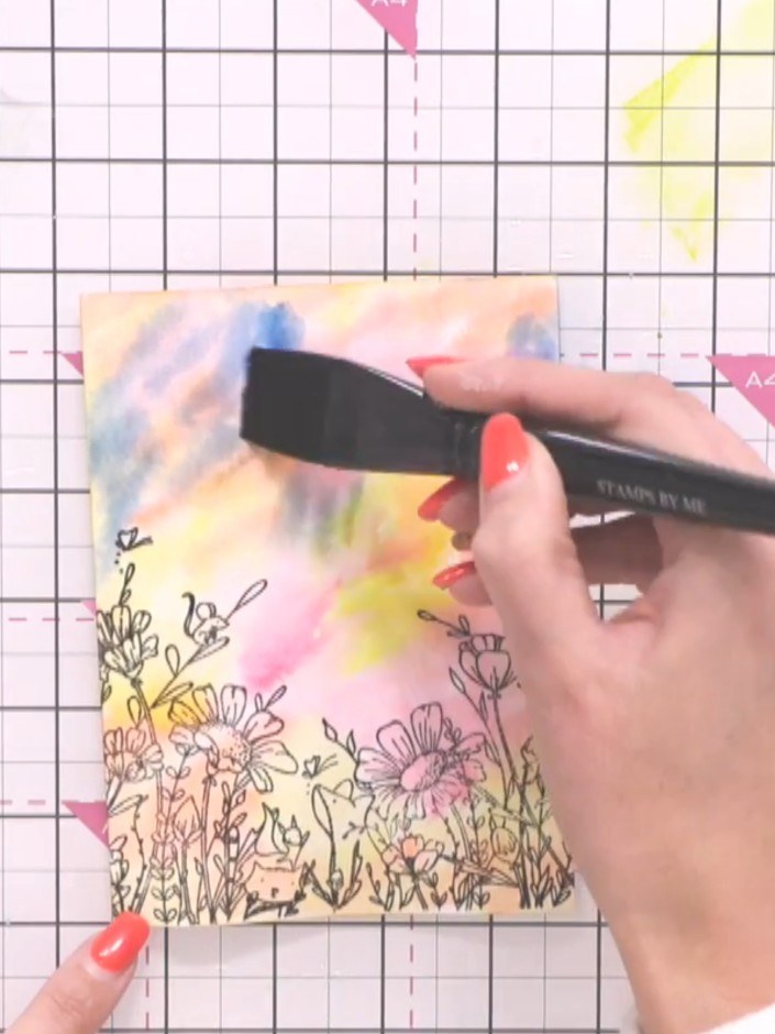 Step 5: Apply teal watercolour towards the top of the card using a brush, keeping it away from the base where the ligh