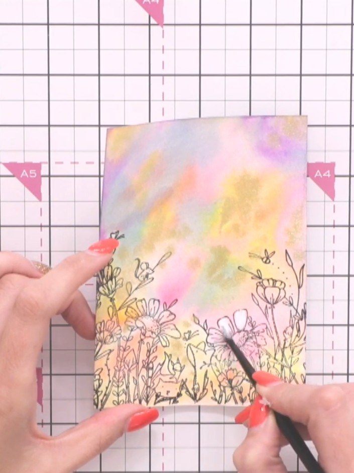 Step 9: Using a fine brush, wet it and apply white watercolour paint to highlight the flower petals. This will bring t