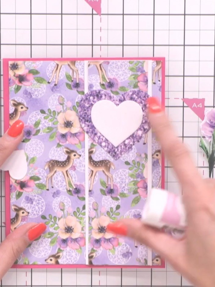 Step 8: Arrange the cascading purple heart die cuts on the card front in your chosen formation. Position them either s