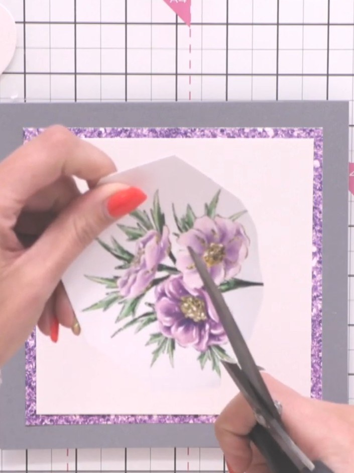 Step 2: Carefully free-cut around the purple floral embellishment on the pre-printed mount. Navigate around the detail
