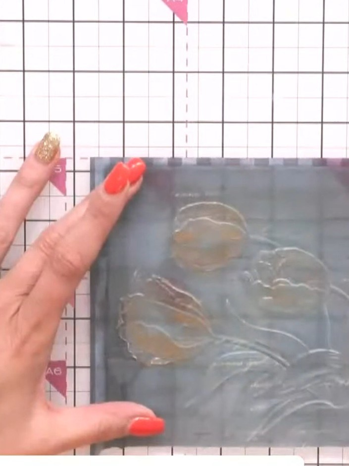 Step 3: Apply gold wax across the embossed detail on the vellum using your finger, working it into the raised areas to