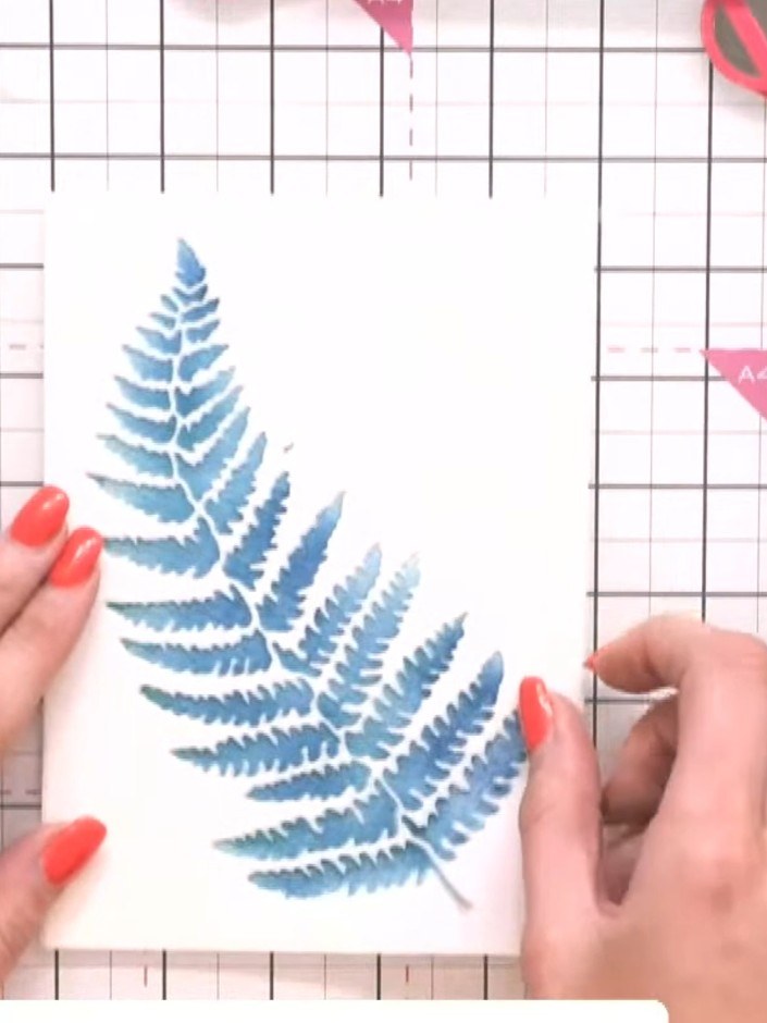 Step 5: Position the fern stencil over the stamped image, slightly offset to create a shadow effect. Apply black ink t