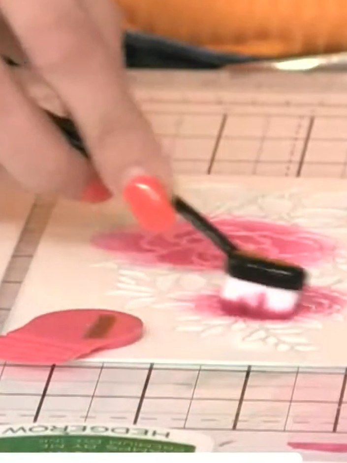 Step 3: Apply purple ink from the ink pad to different areas of the stencil to create colour variation across the flor