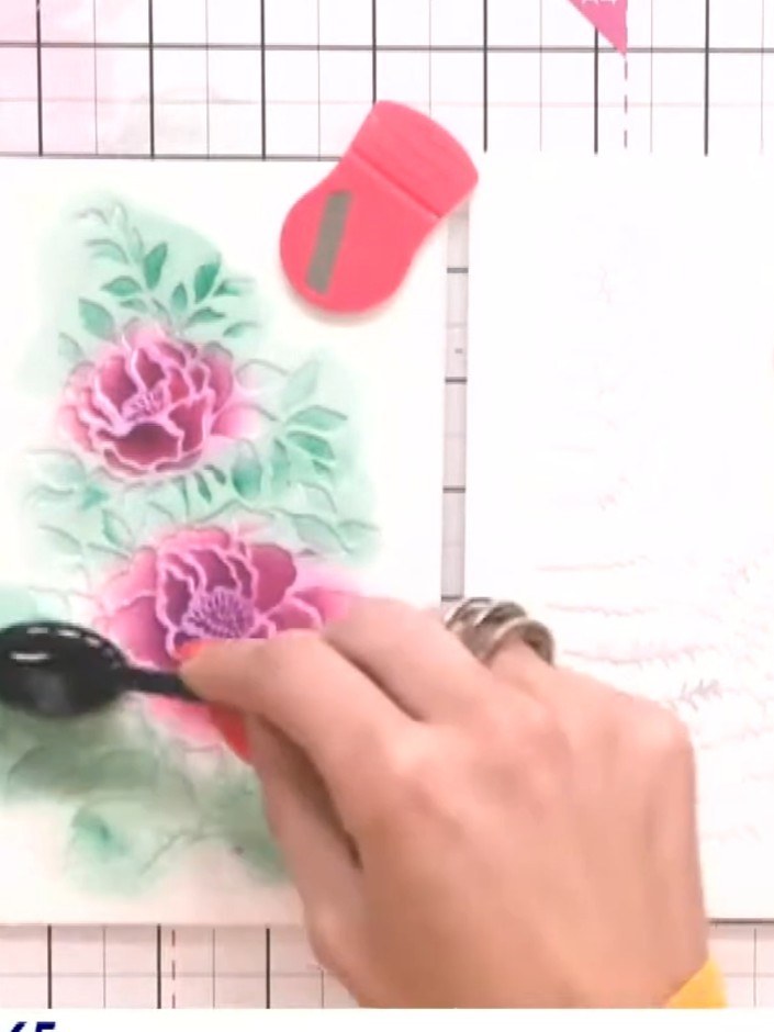 Step 5: Using the teal ink pad, add shading and depth to the floral design by applying ink to the leaves and around th