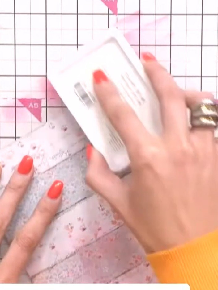 Step 2: Position the floral stencil from the Wistful Charm collection onto your chosen patterned paper from the paper 