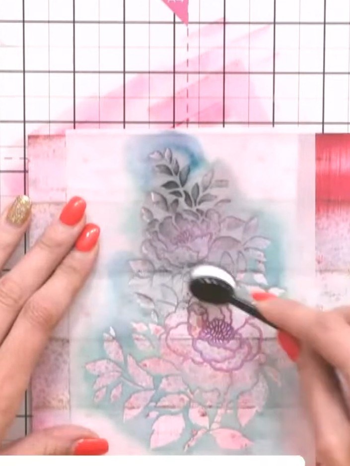 Step 4: Carefully lift the stencil away from the card to reveal the layered floral design beneath. The image should sh