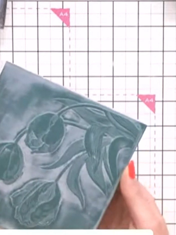 Step 8: Fussy-cut the 'Love' word from the Wistful Charm paper collection using scissors, carefully cutting around the