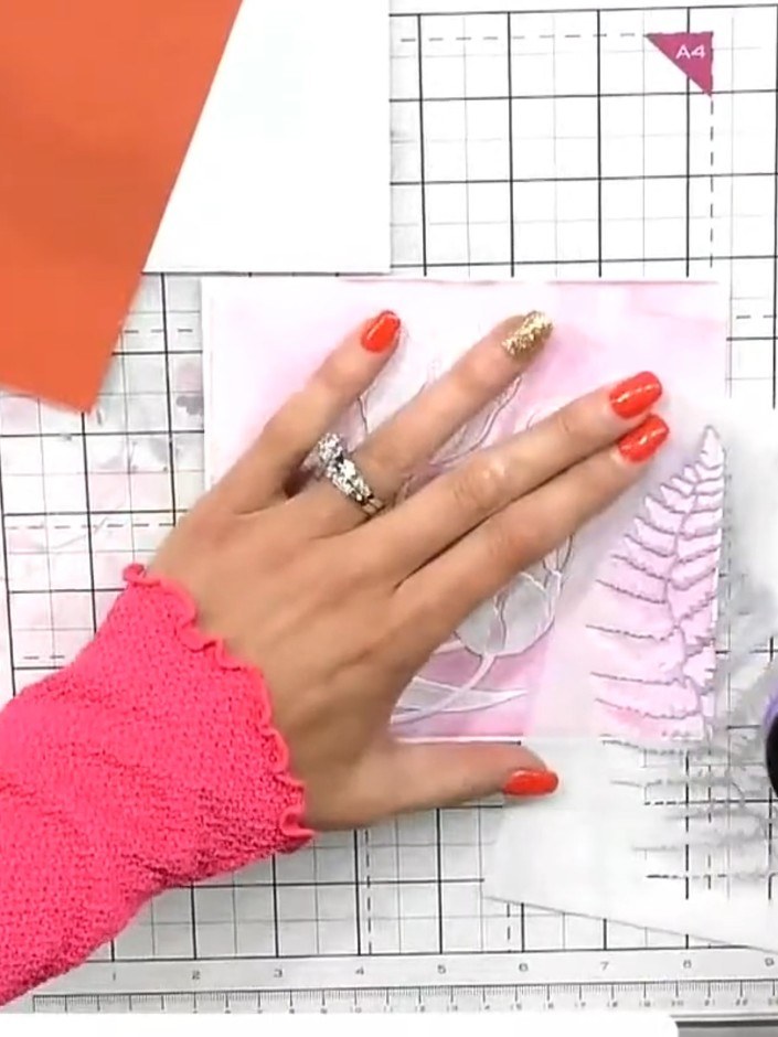 Step 6: Use the fern stencil with black ink to add stencilled detail over the embossed pattern on the pink card panel.