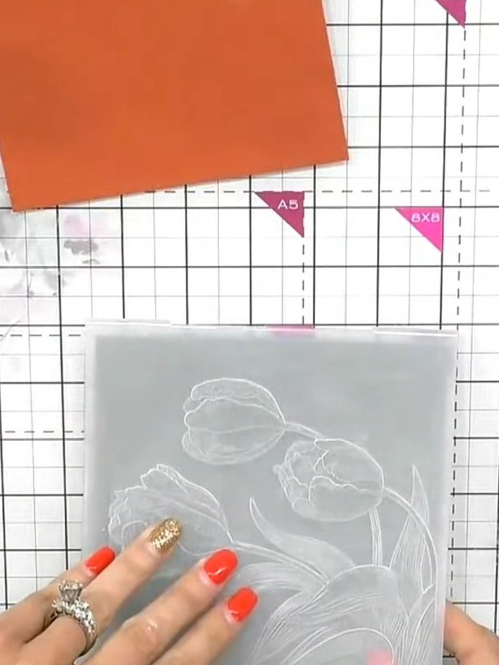 Step 1: Take a 5 by 7 inch grey card blank and place it inside the Tulip embossing folder.