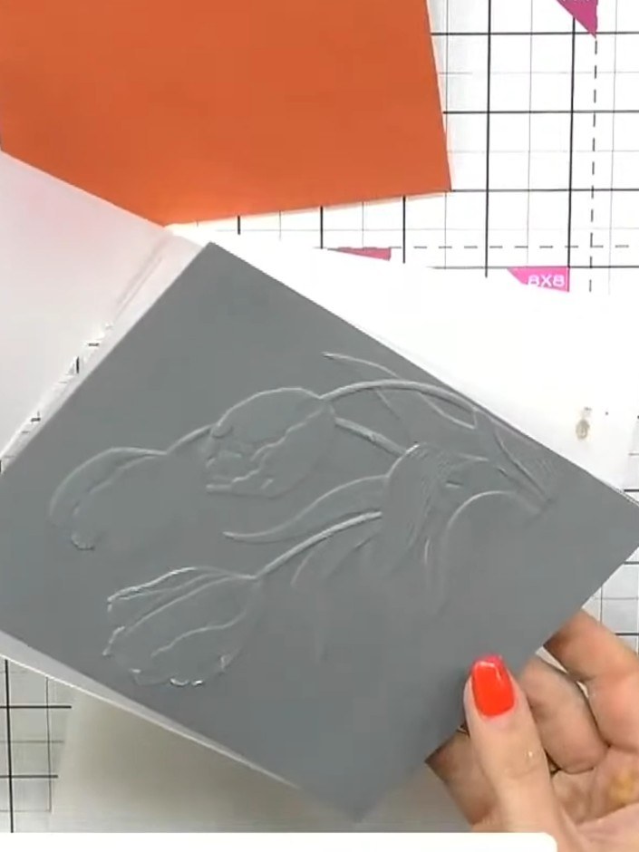 Step 4: Take a sheet of patterned vellum and place it inside the same Tulip embossing folder, ensuring the vellum cove