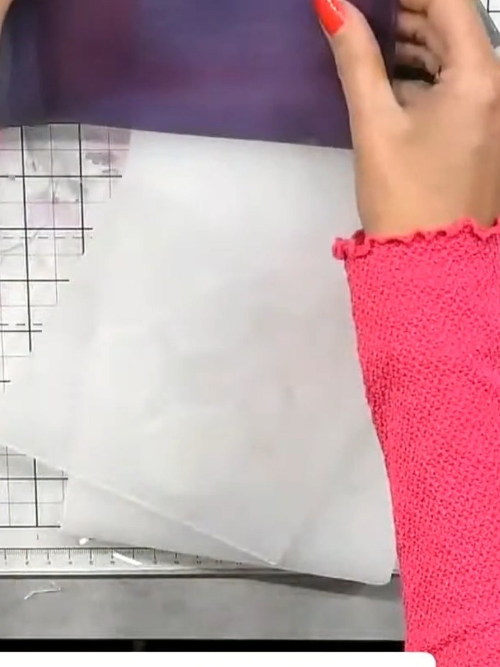 Step 6: Carefully tear the vellum to isolate the best part of the embossed design, removing any unwanted areas whilst 