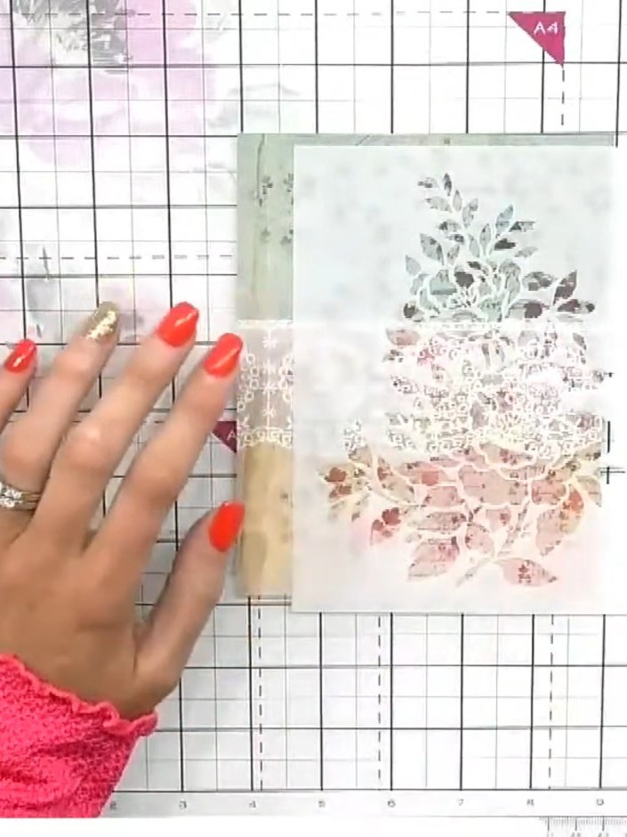Step 1: Position the floral stencil on your patterned paper, placing it slightly off-centre for a more natural, organi