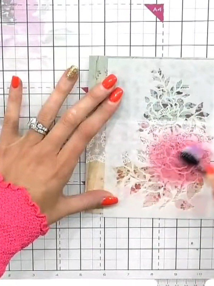 Step 2: Tap pink ink through the floral stencil using a blending brush with light, controlled taps. Work gently to bui