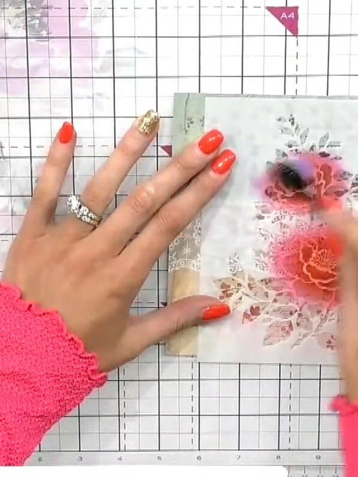 Step 3: Apply orange ink to the card using a blending sponge, creating a warm halo effect around the stamped flowers. 