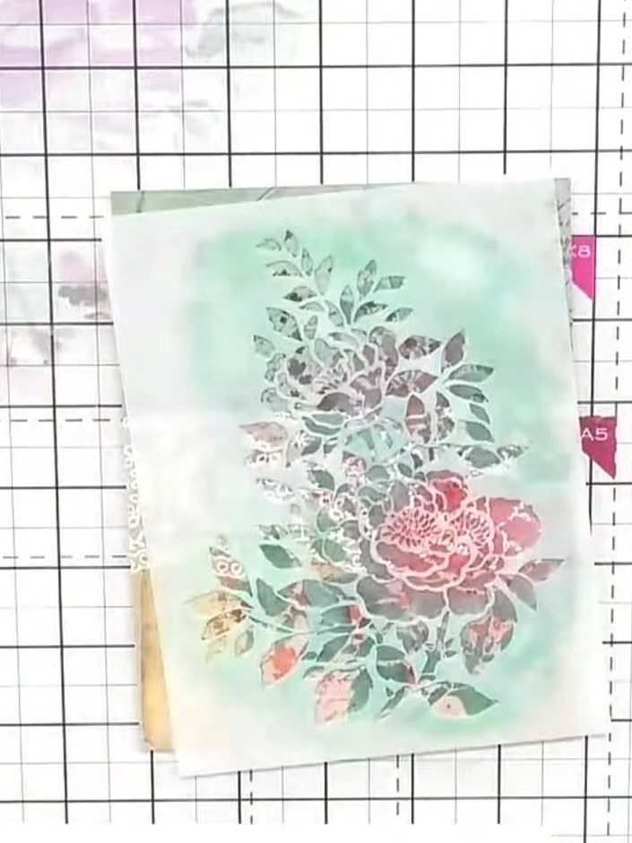 Step 5: Carefully lift and remove the stencil to reveal the softened, highlighted floral design with the white ink cre