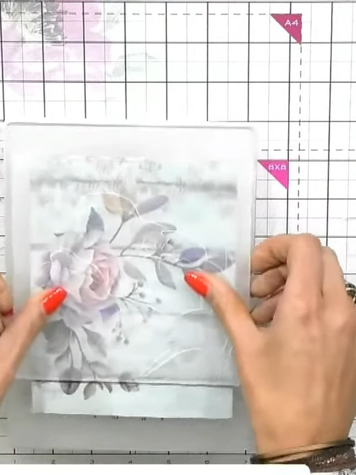 Step 1: Place the painted mount into your embossing folder, ensuring it is positioned correctly so the floral detail w