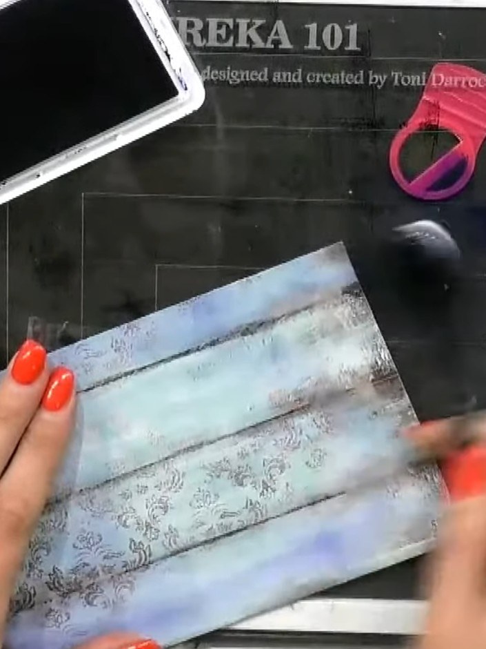 Step 2: Use a brush to blend and drag the blue ink downwards across the paper, creating a gradient effect. Swipe the i