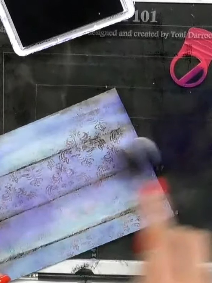 Step 3: Apply purple ink from the Stamps By Me Ink Pad 'Brights' Collection to the background, blending it with the bl
