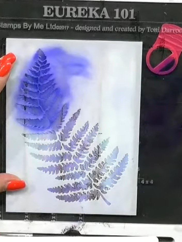 Step 5: Carefully lift the stencil away from the card to reveal the layered fern design. Wipe the stencil clean on a c