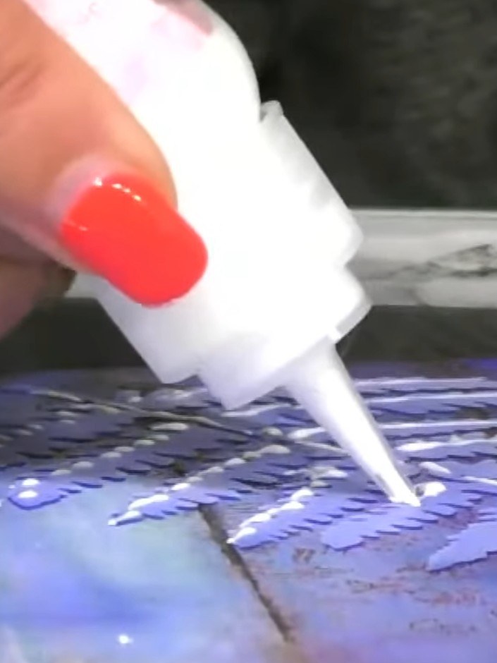 Step 9: Apply clear glitter glue to the fern stencil design on your card. The glue dries clear and will add a subtle g